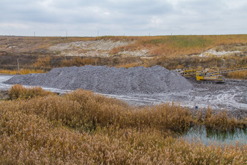 A powerful dragline excavator works in a clay quarry