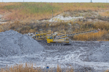 A powerful dragline excavator works in a clay quarry