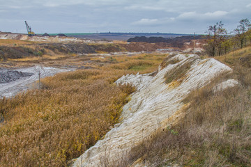 A powerful dragline excavator works in a clay quarry