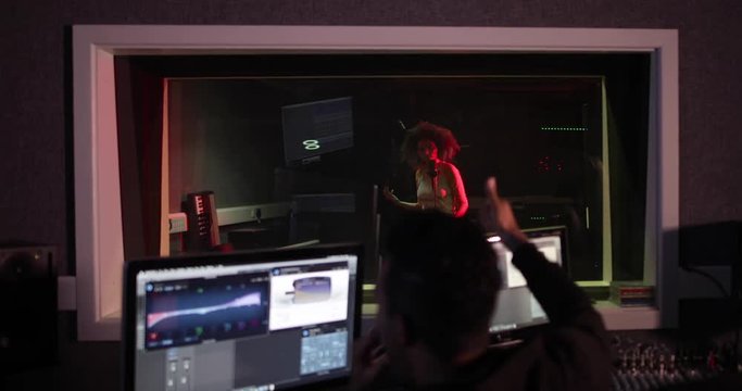 Music producer working with band in recording studio