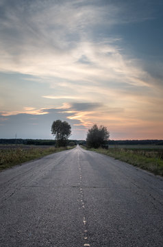 Empty asphalt country road during sunset