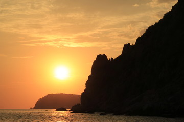 Beautiful sunset, rocky coast of Cape Fiolent. Dramatic scene. Crimea