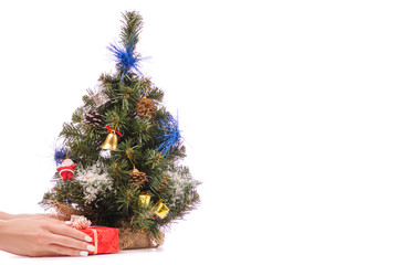 Little Christmas tree toys gift presentation in a hand