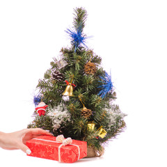 Little Christmas tree toys gift presentation in a hand
