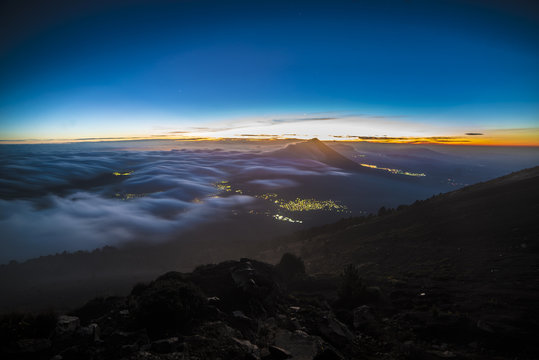 Clear Sky in the Dusk from the top of mountain, Volcano & city in foggy sunrise, guatemala, acatenango, volcan de agua
