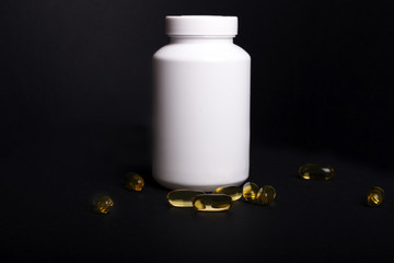 White bottle with omega-3 capsules around on black background