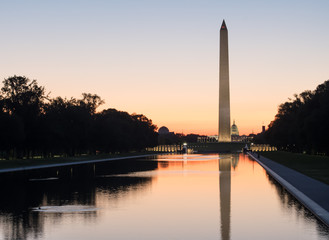 Fototapeta na wymiar Washington memorial reflection in water at sunrise sunset tranquil in the capital city, Washington DC United States of America U.S. 
