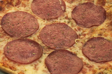 Baked salami pizza with cheese