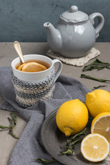 Cup of tea with lemon on table close-up. Healthcare traditional medicine and flu treatment concept.