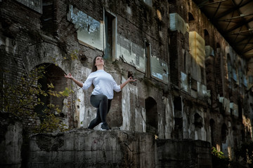 Fototapeta na wymiar Girl doing yoga in an old abandoned building