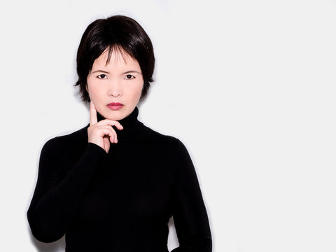 A portrait of an oriental woman wearing a black turtleneck sweater