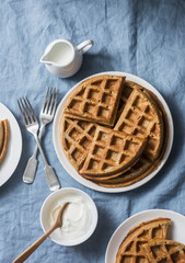 Savory gluten free breakfast waffles on a blue background, top view. Vegetarian food concept