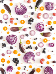 Composition of vegetables and fruits on a white background. Pattern made from fresh vegetables and fruits. Top view, flat design. Collage of red cabbage in a cut, eggplants, plums, grapes, mandarins.