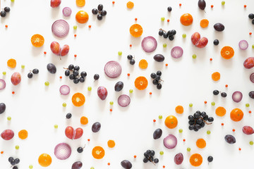Composition of vegetables and fruits on a white background. Pattern made from fresh vegetables and fruits. Top view, flat design. Collage of eggplants, plums, grapes, mandarins.