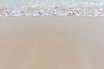 Beautiful Soft wave on sandy beach background