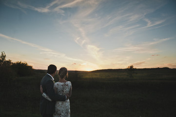 Portrait of a young couple in love on sunset background 227.