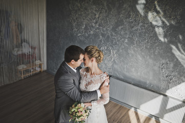 The gentle embrace of the newlyweds in the Studio 325.