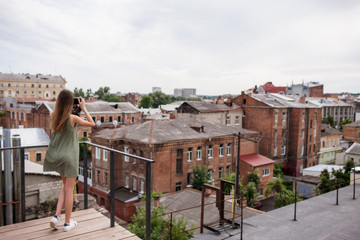 Cityscape woman photoshoot roof concept. Working process. Photographer lifestyle.