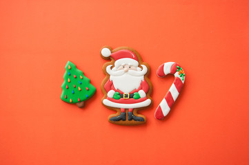 Festive Christmas concept background. Santa, fir tree, and candy canes gingerbread  cookies. Top view.