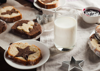 homemade breakfast - rustic style, milk, cupcake, jam on a wooden background