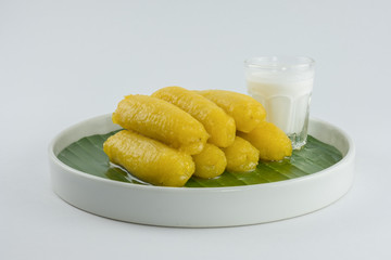 Preserved banana in syrup, Thai style, served on a white background.