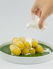 Preserved banana in syrup, Thai style, served on a white background.