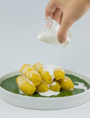 Preserved banana in syrup, Thai style, served on a white background.