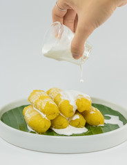 Preserved banana in syrup, Thai style, served on a white background.