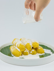 Preserved banana in syrup, Thai style, served on a white background.