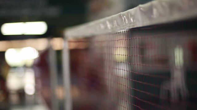 Badminton net on a badminton courts with bokeh lights on blurred background. 1920x1080