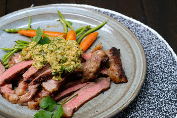 Close up Steak with Green Olive Pesto. (selective focus)