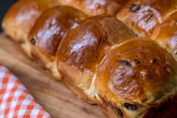 Close up Homemade raisin bread on a wooden cutting board. (Selective focus)