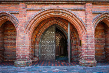 Entrance arch to Catholic Church of Gothic style of red brick. Brick arches in the Catholic cathedral st. Anne in Vilnius, Lithuania