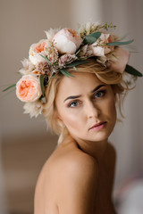 Romantic topless look of attractive blonde woman in a floral wreath