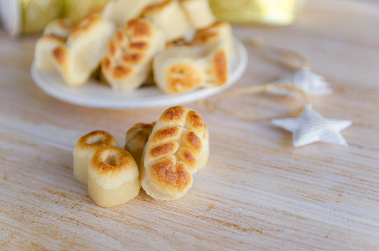 Close up of Spanish Christmas marzipan sweets, Figuritas de mazapan with christmas decoration on wooden table. Traditional treat consumed during winter holidays in Spain.