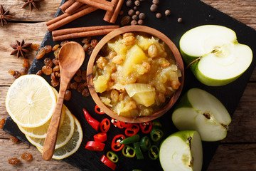 Spicy Indian sauce - apple chutney with lemon close-up in a bowl. horizontal top view