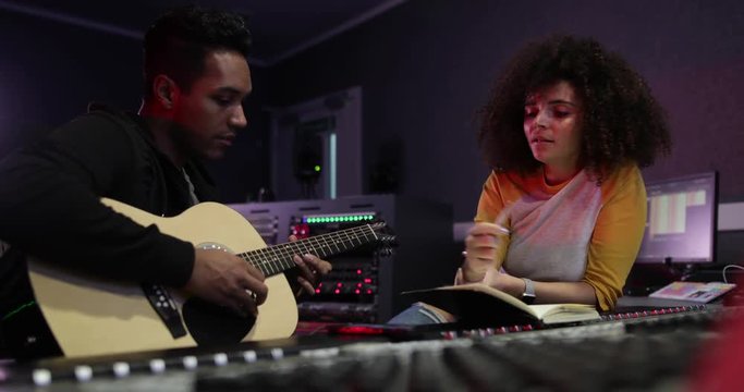 Songwriter writing lyrics in a music recording studio