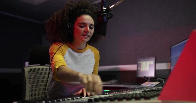 Female radio DJ in a recording studio