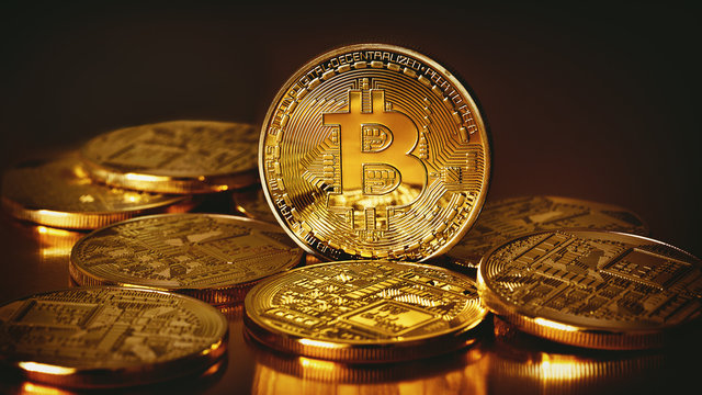 Golden Bitcoins on a gold background .Photo (new virtual money ) New crypto currency in the form of the coins.