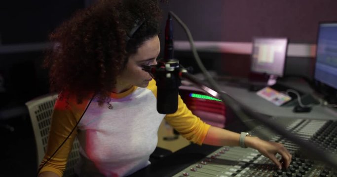 Female radio DJ in a recording studio