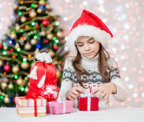 girl is packing a Christmas present