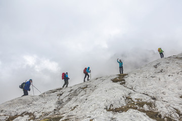 Tourists reaches the top of a rocky mountain