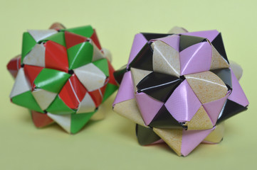 Modular origami, sonobe ball, on yellow background