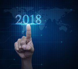 Hand pressing 2018 text over digital world map technology style, Happy new year concept, Elements of this image furnished by NASA