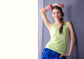 Attractive young woman standing on grey background