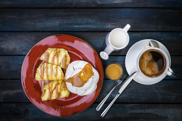 Delicious dessert. Meringue with pineapple and fresh coffee on a colored wooden background. Top view
