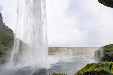view of Seljalandsfoss waterfall from cave