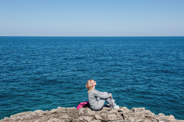 Woman tourist in Polignano, Apulia, Italy, in a summer day