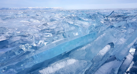 Fototapeta na wymiar Frozen ice hummocks and ice cracks with blue sky during winter in Lake Baikal, Siberia, Russia