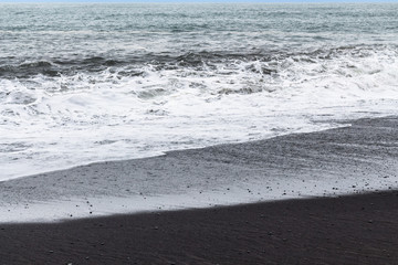 ocean surf on Reynisfjara black beach in Iceland